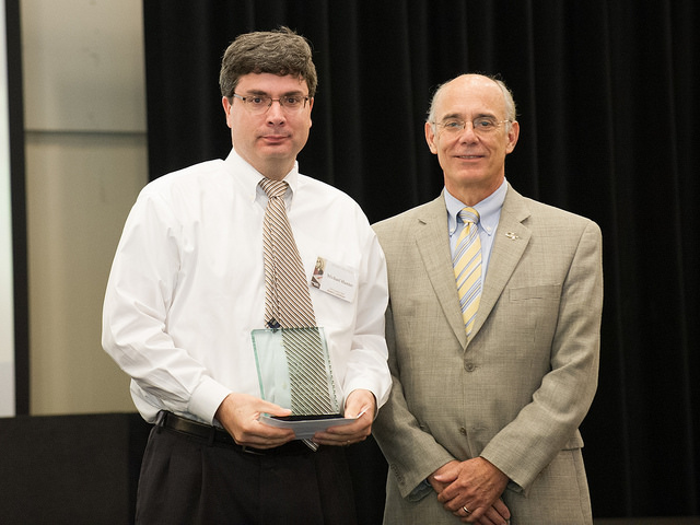 <span style="font-size:10px"> Dr. Hunter receives his award</span>